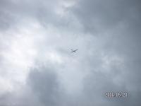 Glider beneath clouds
